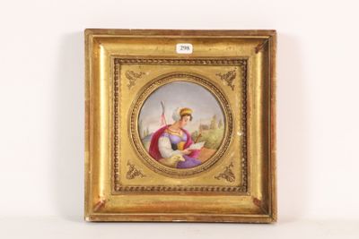 an old picture of a woman holding a book in a gold frame
