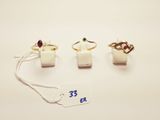 three rings and a tag on a white surface