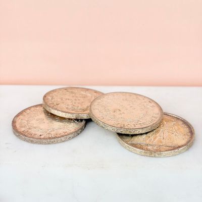 four coins sitting on top of each other on a table