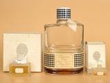 a bottle of perfume sitting next to a box of soap