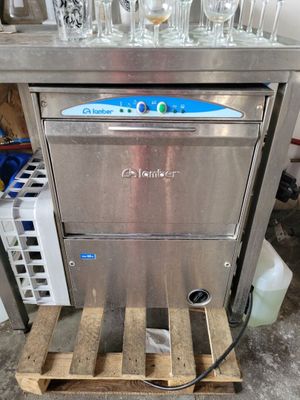 an image of a stainless steel counter top dishwasher with wine glasses on it