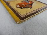 a yellow book with a picture of a man driving a car
