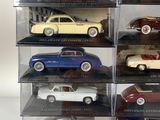six different models of cars in a display case