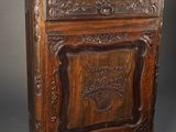 an old wooden cabinet with carvings on the front and a drawer on the back