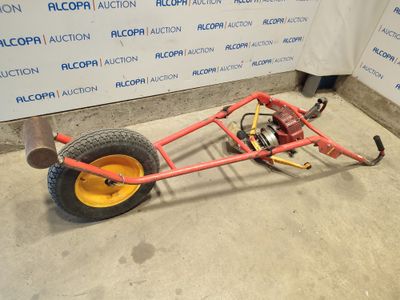 a small red cart with a yellow wheel on the floor