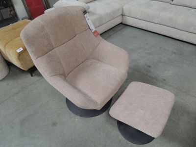 a chair and ottoman in a store with a lot of furniture in the background