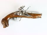 a small wooden gun that is on a white surface