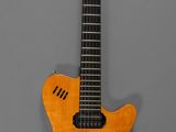 an electric guitar with a wooden body on a gray background