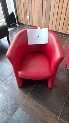 two red chairs with a sign on them in a room