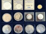 an assortment of silver and gold coins in a display case