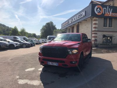 a picture of a red truck parked in front of a building