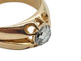 an image of a close up of a gold ring with a diamond
