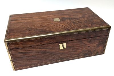 an old wooden box with a metal handle on a white surface