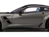 the silver sports car is parked on the side of the road
