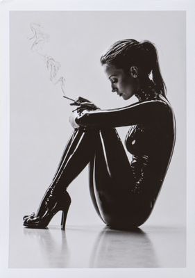 black and white photograph of a woman in latex smoking a cigarette