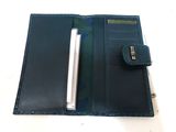 wallet with pen and notepad in it on a white surface