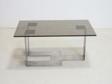 an image of a glass and metal coffee table