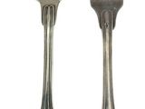 two spoons and a fork sitting next to each other