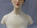 a female mannequin head on a white table