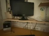 an image of a computer desk with a monitor and keyboard