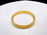 a gold ring sitting on top of a white surface