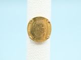a close up of a ring with a gold coin on it