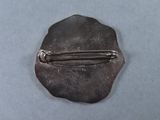 a metal pin with a metal handle on a table