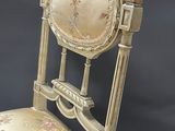 a chair that has a clock on the back of it