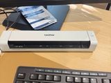 a stapler sitting on top of a desk next to a keyboard
