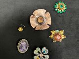 several pieces of jewelry are arranged on a black surface