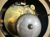 a metal clock with a metal ball in the middle of it