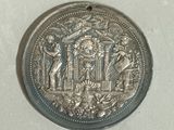 an old silver coin with an image of a man and a woman on it