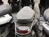 many motor scooters that are parked in a parking lot
