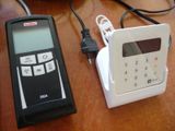 a cell phone sitting next to a charger on a table