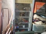 an image of a refrigerator and other junk in a garage