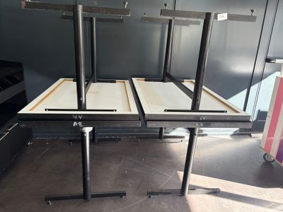 three tables that are sitting in the middle of a room