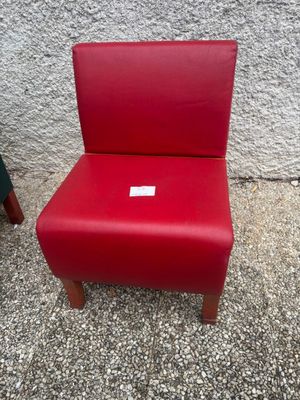 red leather chair with a tag on the back of it