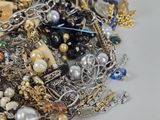 a pile of assorted jewelry sitting on a table
