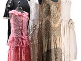 three dresses on mannequins on display on a white background