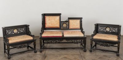 three chairs and a table in a room with a clock on the wall