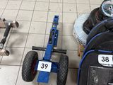 un petit chariot sur lequel sont posés un pneu et un sac à dos