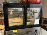 an image of a counter top display case with food in it