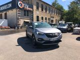 a silver car parked in front of a building