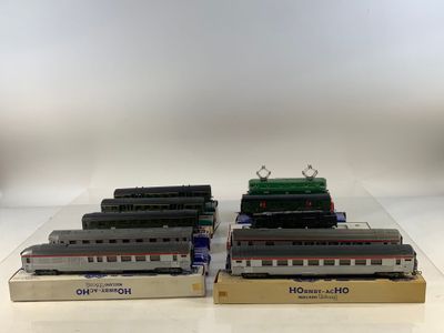 three model trains are sitting on display on a white surface