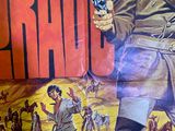 a poster of a man holding a gun in a desert