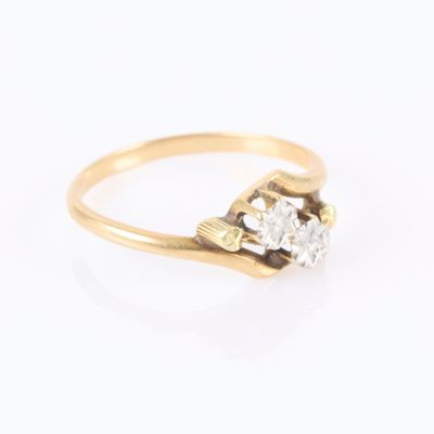 an image of a gold ring with three diamonds on it