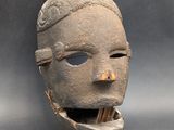 an image of a clay mask with a tooth in it ' s mouth