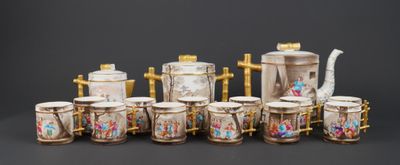 a group of cups and a teapot sitting on a table