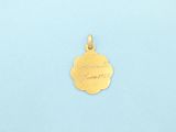 a gold plated pendant with an inscription on it