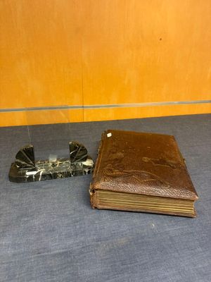 an old book and a lighter on a table